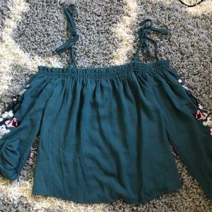 Blouse with floral detail on side of sleeve